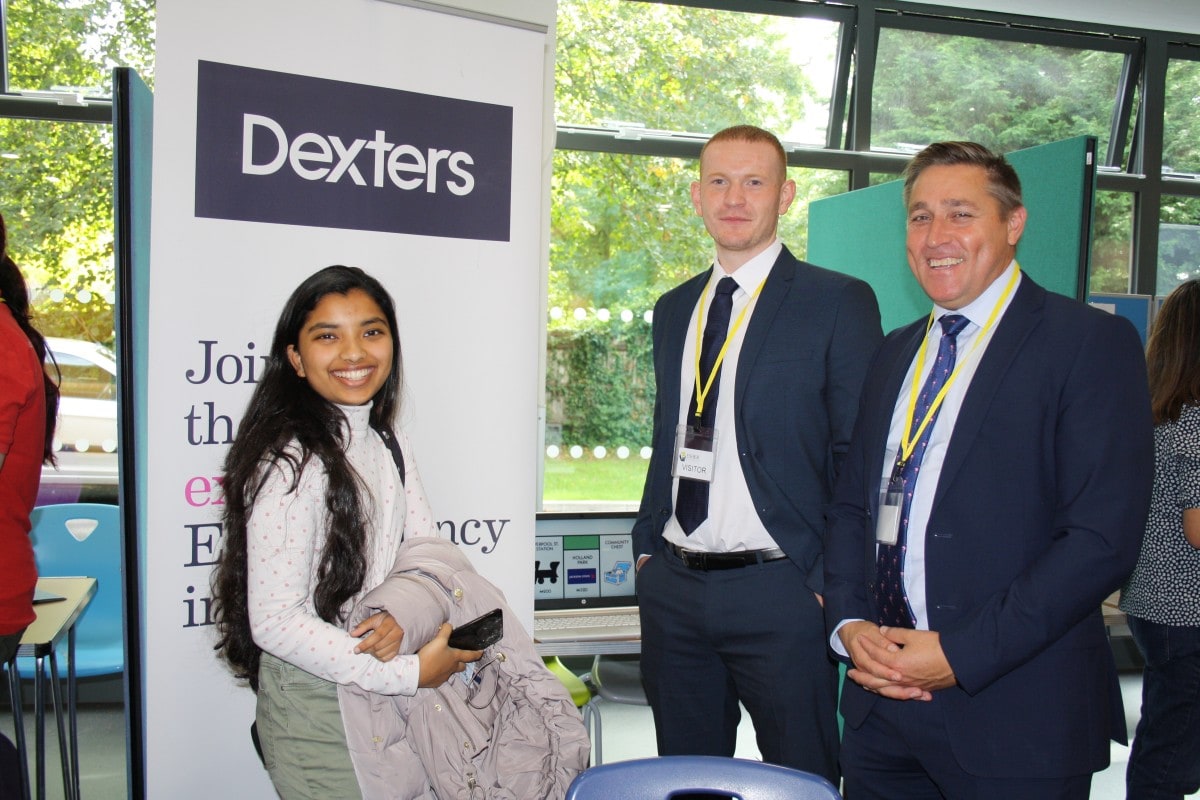 student talks to estate agent Dexters at an exhibition stand