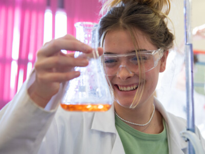 student holding test tube in lab
