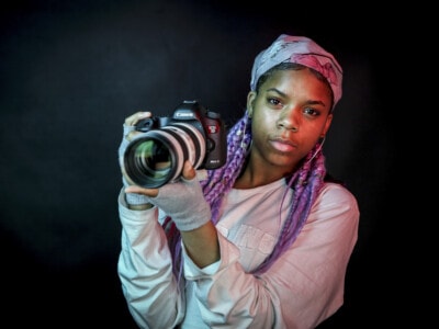 Girl holding camera in photography studio