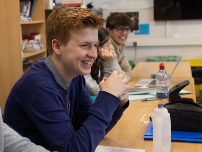 Boy smiling in Politics class