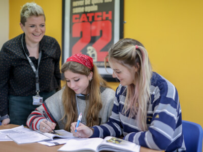 English Literature Teacher Nat Helping Two Female Students