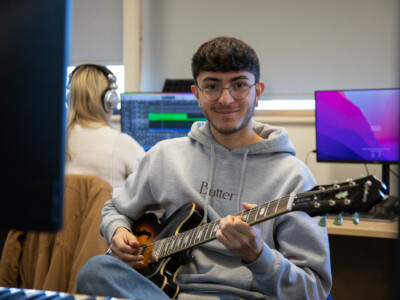 Boy holding a guitar