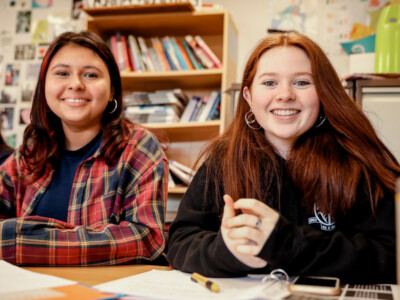 2 girls smiling in Politics class