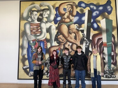 Group of Art and Design Students standing in front of a huge modern art canvas