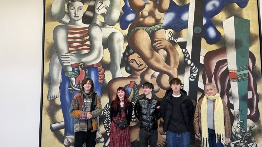 Group of Art and Design Students standing in front of a huge modern art canvas