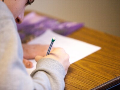 Photo of student writing in an exam