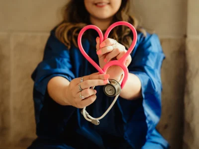 Woman holding heart stethoscope