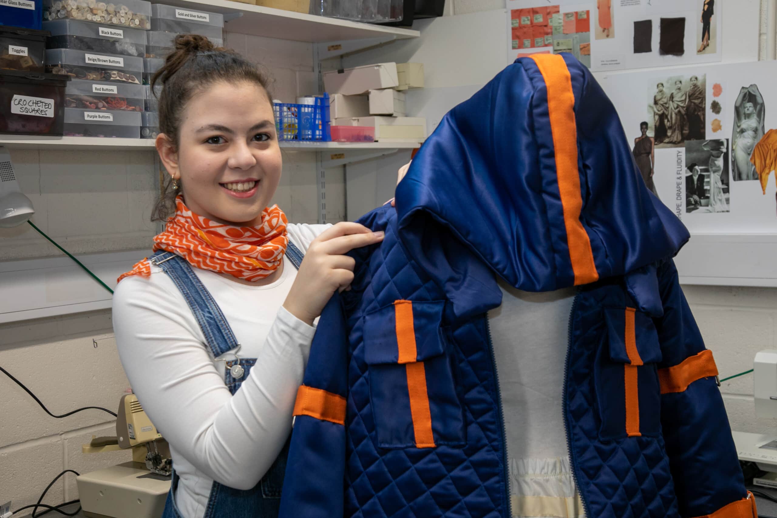 Fashion student Eda standing with garment on mannequin