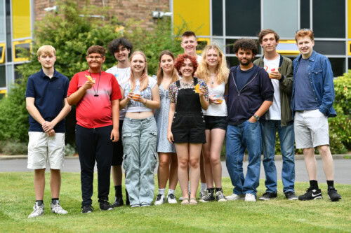 group of students outside Esher Sixth Form college celebrating their results 2024