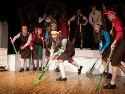 A scene from Daisy Pulls it Off where the student actors are performing a hockey scene