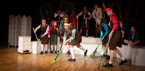 A scene from Daisy Pulls it Off where the student actors are performing a hockey scene