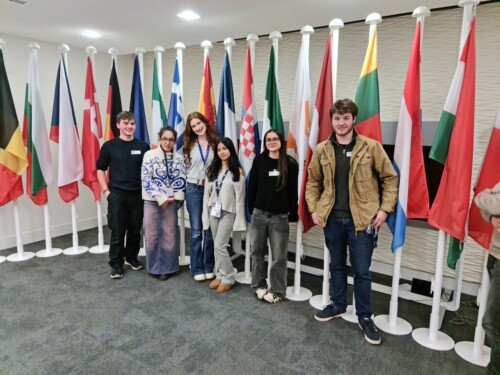 Students with flags inside Europe house