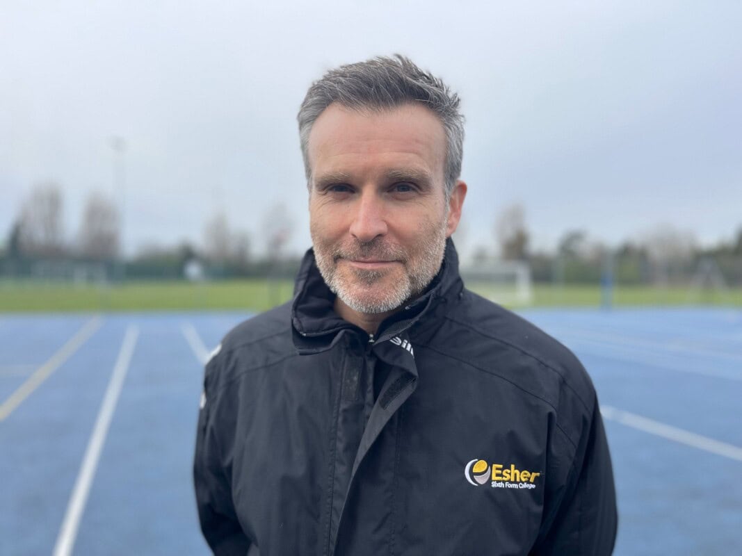 Head shot of PE Teacher Dan Mackley standing on netball court