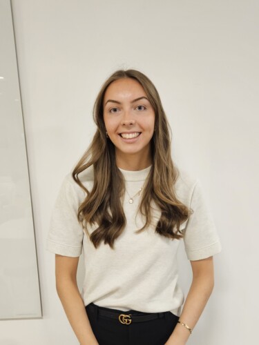 Layla Sheehan standing in front of a plain white wall