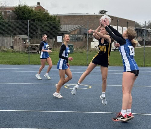 Netballer leaping in the air to defend