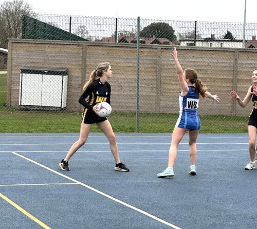 Netballer about to throw the ball to another player