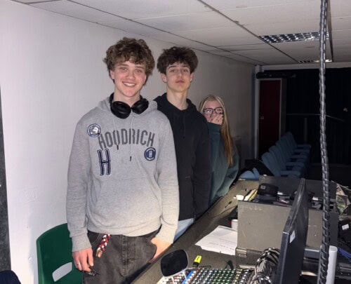 sound tech crew with control board supporting at a college music event