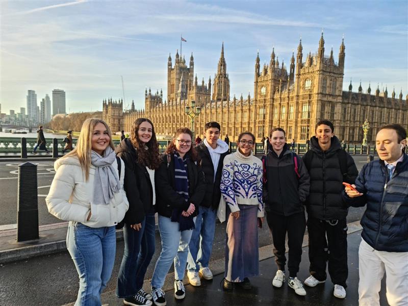 a group of students standing in front of parliament in London